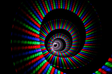 Luminous colors of rainbow trail in form of spiral on background