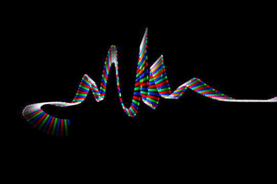 Colorful LED track, in form of waves on black background.