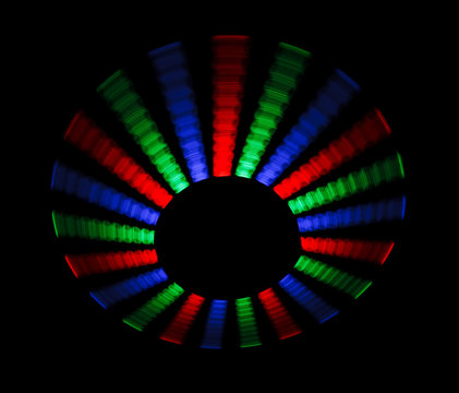 Colorful trace rotating LED in form of disc on a black