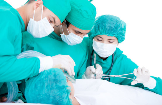 Professionnal medical team using surgery equipment on a patient