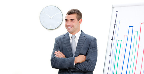 Young businessman with folded arms doing a presentation