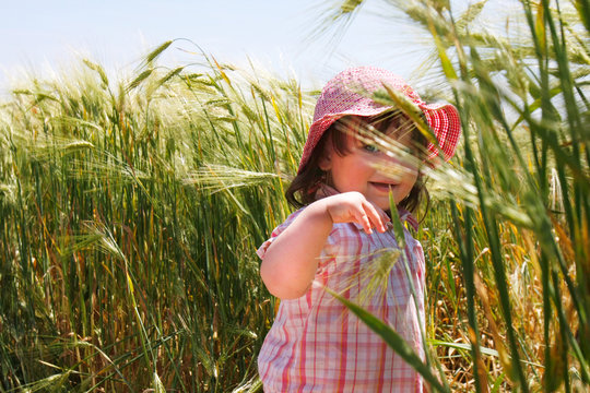 cute toddler girl in green field