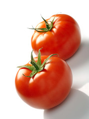 Two tomatoes isolated on white background
