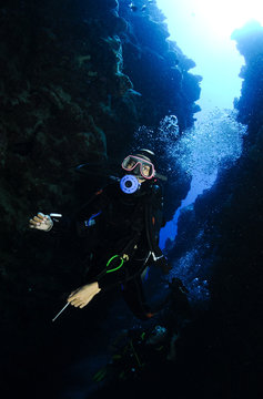 Scuba diver in underwater canyon
