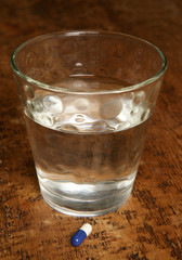 Glass of water and medication