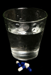 Glass of water and medication