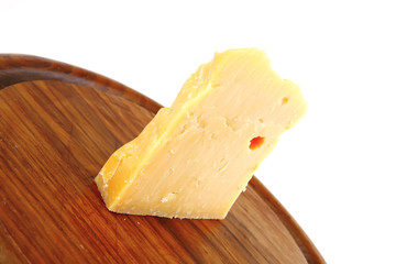 solid gauda cheese on wood