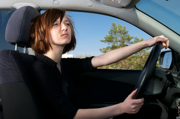 Attractive young female driving car