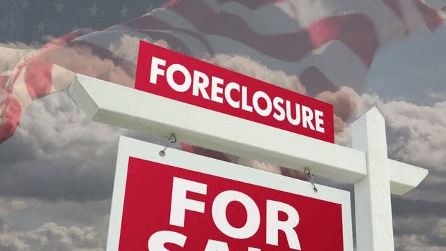 Foreclosure Real Estate Sign Over Flag and Ominous Clouds