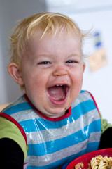 A happy little boy eating