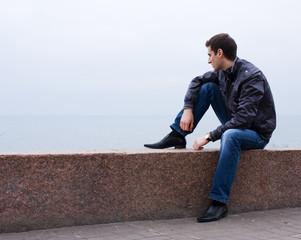 Young man at the embankment