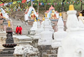 Two monks in red going upstairs Swayambhunath (monkey temple)