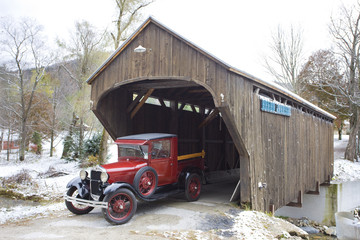 covered wooden bridge with old car, Vermont, USA