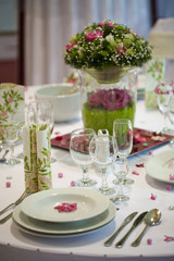 elegant dinner table with flowers and glass