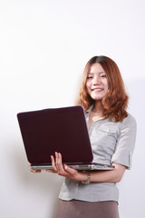 Laughing woman using a laptop  against a white background .
