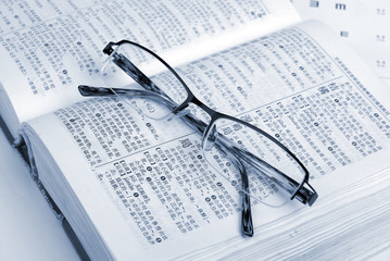 glasses, dicitonary and eye chart