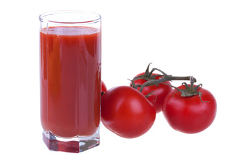 Glass of fresh tomato juice with tomatoes