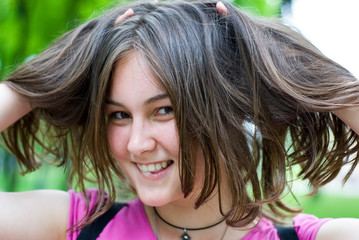 Teen girl with hands in her hair