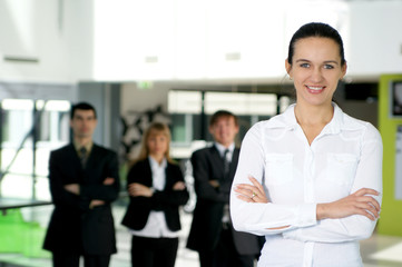 A group of four business persons with a woman in charge