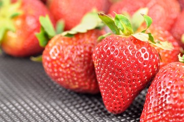 Fresh strawberries on black background