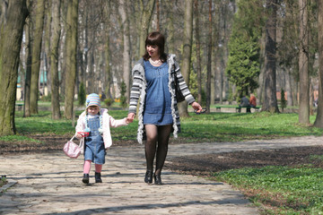 Mother and child take a wolr in park