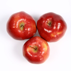 Three red apples on white background