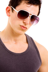 Portrait of stylished young man wearing sunglasses on white back