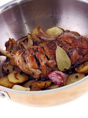 filipino chicken adobo with potatoes in a pan isolated on white