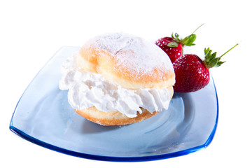 Delicious freshly baked donut with cream and strewbarry