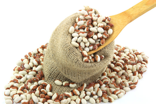 Yellow eye beans burlap sack and wooden spoon.