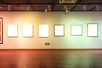 empty frames in a room against a white wall .