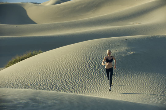 Woman Runs On Sand Dunes