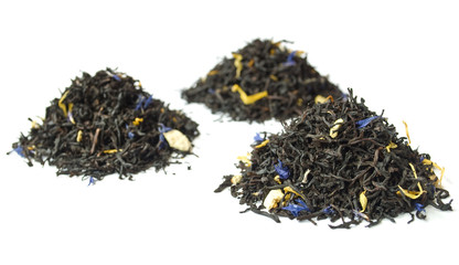 Piles of black tea isolated on white