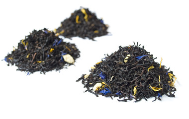 3 piles of black tea isolated on white