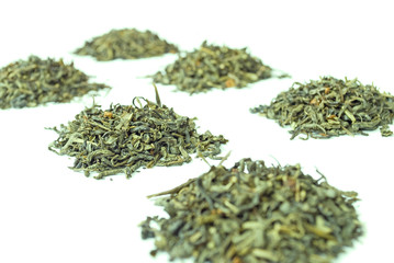 Piles of green tea, isolated on white