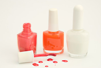 bottles of nail polish over white