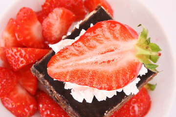 chocolate  cake with cream and  strawberry on white
