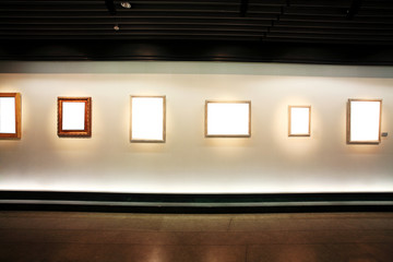empty frames in a room against a white wall .