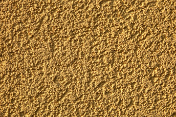 Wall rough surface texture with irregular pattern, closeup view.