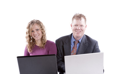 Two adults on computers looking