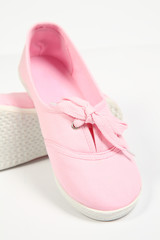 a pair of pink women shoes and white background