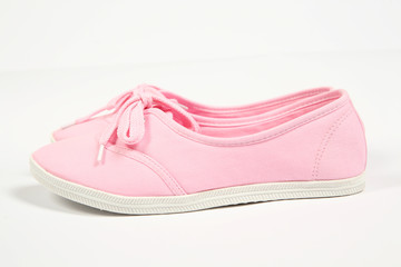 a pair of pink women shoes and white background