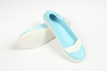 a pair of blue women shoes and white background