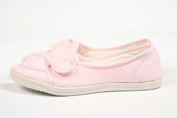 a pair of pink women shoes and white background