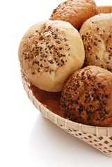 Buns with sesame in a woven basket