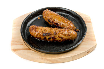 sausages at pan with sauce