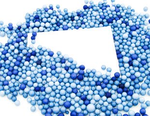 Empty white card in a frame from blue balls