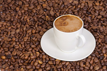 ceramic cup at coffee beans