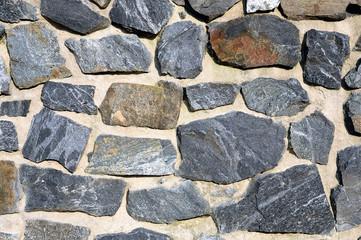 A rough wall made of cemented stones
