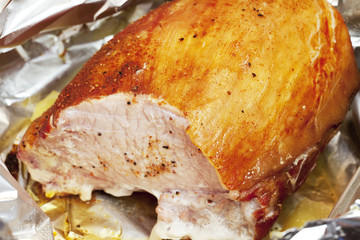 large piece of meat in foil with spices